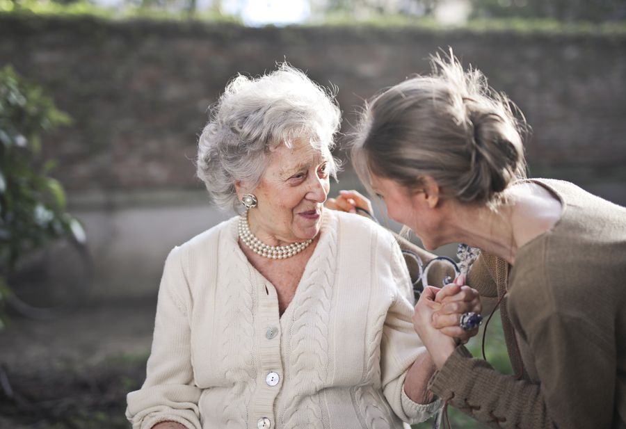 Compassionate caregiver supporting a senior at home